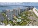 Expansive aerial view of beachfront condos with multiple pools, gardens, and ocean access at 1180 Gulf Blvd # 504, Clearwater Beach, FL 33767