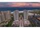 Stunning aerial view of beachfront condos, manicured grounds, and ocean at sunset at 1180 Gulf Blvd # 504, Clearwater Beach, FL 33767