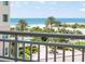 Enjoy stunning ocean views from this condo's balcony overlooking lush landscaping, palm trees, and a sparkling beach at 1180 Gulf Blvd # 504, Clearwater Beach, FL 33767