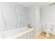 A modern bathroom featuring a tub and shower with gold fixtures, along with a toilet at 1180 Gulf Blvd # 504, Clearwater Beach, FL 33767