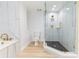Clean and well-designed bathroom featuring glass shower, tub, and marble-look walls at 1180 Gulf Blvd # 504, Clearwater Beach, FL 33767
