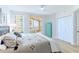 Bright bedroom with modern decor, balcony access, and white closet doors at 1180 Gulf Blvd # 504, Clearwater Beach, FL 33767