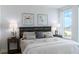 Bright bedroom featuring a decorative headboard, bedside tables with lamps, and window views at 1180 Gulf Blvd # 504, Clearwater Beach, FL 33767
