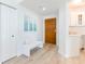 Well-lit entryway with a white bench, attractive flooring, and access to the kitchen and other living spaces at 1180 Gulf Blvd # 504, Clearwater Beach, FL 33767