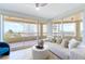 Bright living room boasts floor-to-ceiling windows offering stunning views and floods of natural light at 1180 Gulf Blvd # 504, Clearwater Beach, FL 33767