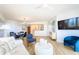 Inviting living room with hardwood floors, modern furniture, a flat-screen TV, and seamless flow to the kitchen at 1180 Gulf Blvd # 504, Clearwater Beach, FL 33767