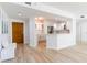 Open-concept living space featuring hardwood floors, a white kitchen, and an inviting atmosphere for entertaining at 1180 Gulf Blvd # 504, Clearwater Beach, FL 33767