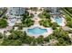 Overhead view of community pools, lush landscaping, and gardens between condo buildings at 1180 Gulf Blvd # 504, Clearwater Beach, FL 33767