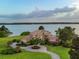 Stunning aerial view of a waterfront mansion with lush landscaping and a winding driveway at 12125 Stonelake Ranch Blvd, Thonotosassa, FL 33592