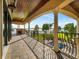 Over-sized balcony with decorative ironwork, an outdoor fireplace, and a view of the lake and backyard at 12125 Stonelake Ranch Blvd, Thonotosassa, FL 33592