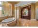 Bright primary bathroom with a soaking tub, vanity area, and a walk-in shower at 12125 Stonelake Ranch Blvd, Thonotosassa, FL 33592