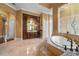 Well-lit primary bathroom with a soaking tub, vanity, and a separate shower at 12125 Stonelake Ranch Blvd, Thonotosassa, FL 33592