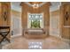 Elegant bathroom featuring a large soaking tub, arched windows, and marble flooring at 12125 Stonelake Ranch Blvd, Thonotosassa, FL 33592