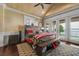 Main bedroom featuring high ceilings, fan, wood floors, and waterfront views at 12125 Stonelake Ranch Blvd, Thonotosassa, FL 33592