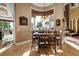 Bright dining area features a wooden table, elegant chandelier, and a scenic waterfront view at 12125 Stonelake Ranch Blvd, Thonotosassa, FL 33592