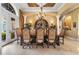 Formal dining room with elegant lighting, columns, and custom wood trim at 12125 Stonelake Ranch Blvd, Thonotosassa, FL 33592