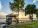 Wooden dock with boat lift, sun deck and sunset lake views at 12125 Stonelake Ranch Blvd, Thonotosassa, FL 33592