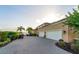 Long driveway and large garages with view of the lake beyond at 12125 Stonelake Ranch Blvd, Thonotosassa, FL 33592