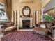 Elegant foyer featuring a decorative fireplace, ornate mirror, and plush seating, perfect for welcoming guests at 12125 Stonelake Ranch Blvd, Thonotosassa, FL 33592