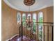 Foyer chandelier view of the staircase and front yard with wrought iron banister at 12125 Stonelake Ranch Blvd, Thonotosassa, FL 33592