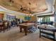 Spacious game room featuring a pool table, air hockey table, bar, and ample space for entertaining guests at 12125 Stonelake Ranch Blvd, Thonotosassa, FL 33592