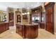 Gourmet kitchen with center island, custom cabinetry, granite counters and stainless appliances at 12125 Stonelake Ranch Blvd, Thonotosassa, FL 33592