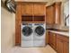 Functional laundry room with modern washer and dryer units and ample storage space at 12125 Stonelake Ranch Blvd, Thonotosassa, FL 33592