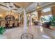 Spacious living area with high ceilings, decorative columns, chandelier, and lake views at 12125 Stonelake Ranch Blvd, Thonotosassa, FL 33592