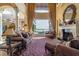 A sun-drenched living room with lake view has a fireplace and luxury furniture at 12125 Stonelake Ranch Blvd, Thonotosassa, FL 33592