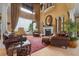 Elegant living room featuring high ceilings, large windows, a fireplace, and comfortable seating at 12125 Stonelake Ranch Blvd, Thonotosassa, FL 33592