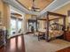Luxurious main bedroom boasts a four-poster bed, water views, and access to the pool area at 12125 Stonelake Ranch Blvd, Thonotosassa, FL 33592