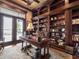 A stately home office featuring a built-in bookcase and a beautiful desk with water view at 12125 Stonelake Ranch Blvd, Thonotosassa, FL 33592