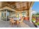Covered outdoor dining area with a kitchen and scenic views of the backyard and waterfront at 12125 Stonelake Ranch Blvd, Thonotosassa, FL 33592