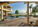 Beautiful outdoor living space with a pool, manicured lawn, and a serene lake view for your enjoyment at 12125 Stonelake Ranch Blvd, Thonotosassa, FL 33592