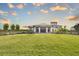 Stunning exterior of home with manicured lawn, large windows, and modern architectural details at 12580 Somatic Ct, Venice, FL 34293