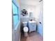 Bathroom featuring a toilet and sink next to a large window with decorative accents at 1300 21St S St, St Petersburg, FL 33712