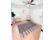 Cozy bedroom with wood floors, a decorative mirror, accent chair, and a bright window at 1300 21St S St, St Petersburg, FL 33712