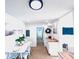 Cozy dining area and kitchen showcasing white cabinetry, butcher block countertops, and modern appliances at 1300 21St S St, St Petersburg, FL 33712