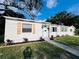 Charming home featuring a bright exterior, complemented by neat landscaping and decorative window shutters at 1300 21St S St, St Petersburg, FL 33712