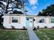Home exterior with light blue door, decorative shutters, landscaping, and a decorative star accent at 1300 21St S St, St Petersburg, FL 33712