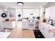 Open-concept kitchen with white cabinets, butcher block countertops, and modern appliances at 1300 21St S St, St Petersburg, FL 33712