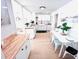 Well-lit kitchen featuring white cabinets, butcher block countertops, and a modern dining area at 1300 21St S St, St Petersburg, FL 33712