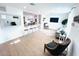 Inviting living room featuring wood floors, modern decor, comfortable seating, and a large decorative mirror at 1300 21St S St, St Petersburg, FL 33712