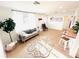Bright living room featuring a comfortable gray couch, modern decor, and hardwood floors at 1300 21St S St, St Petersburg, FL 33712
