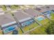 Aerial view of a home with a screened-in pool, showcasing the backyard and surrounding neighborhood at 13527 Willow Bluestar Loop, Riverview, FL 33579