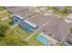 Aerial view of residences featuring screened pools, manicured lawns, and fenced backyards at 13527 Willow Bluestar Loop, Riverview, FL 33579