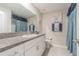 Clean bathroom featuring a granite countertop, modern vanity, and a decorative shower curtain at 13527 Willow Bluestar Loop, Riverview, FL 33579