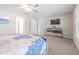 Primary bedroom boasting a ceiling fan, plush carpet, natural light, and contemporary furnishings at 13527 Willow Bluestar Loop, Riverview, FL 33579
