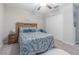 Cozy bedroom featuring a comfortable bed, white rug, ample closet space, and a ceiling fan at 13527 Willow Bluestar Loop, Riverview, FL 33579
