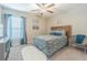 Serene bedroom with a queen-size bed, soft rug, and a large window for natural light at 13527 Willow Bluestar Loop, Riverview, FL 33579